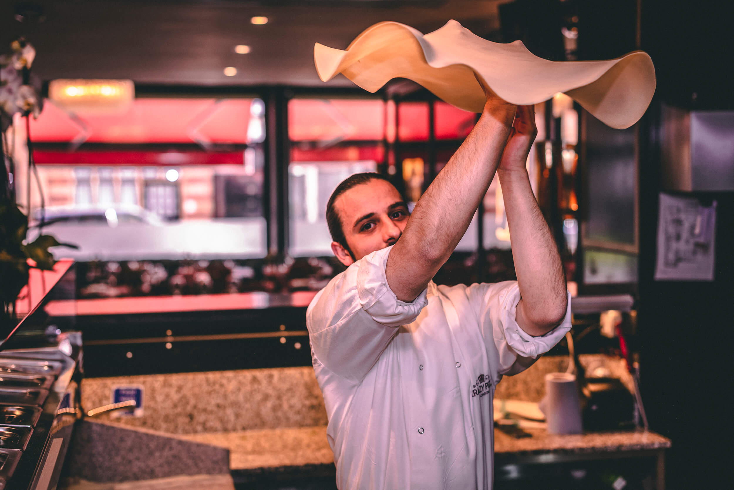 Pizza chef spinning dough.